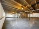 Unfinished basement with exposed wooden beams, concrete floor, and white wrapped walls at 643 Bracknell Dr, Avon, IN 46123