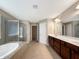 Bathroom featuring double vanity, separate shower, and soaking tub for a luxurious experience at 643 Bracknell Dr, Avon, IN 46123