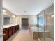 Spacious bathroom with double vanities, a soaking tub, and a glass-enclosed shower at 643 Bracknell Dr, Avon, IN 46123