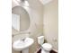 Well-lit powder room featuring a pedestal sink, round mirror, and neutral paint at 643 Bracknell Dr, Avon, IN 46123