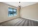 Neutral bedroom with large window offering natural light, and modern light fixture at 643 Bracknell Dr, Avon, IN 46123