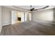 Spacious bedroom with neutral walls, plush carpet, and a view to the bathroom and closet at 643 Bracknell Dr, Avon, IN 46123