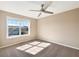 Bright bedroom with a large window, carpet flooring, and a modern ceiling fan at 643 Bracknell Dr, Avon, IN 46123