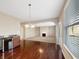 Dining area with wood floors, bright window light, and an arched entryway to the living room at 643 Bracknell Dr, Avon, IN 46123