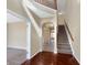 Elegant foyer with gleaming hardwood floors, staircase, arched doorway, and neutral paint at 643 Bracknell Dr, Avon, IN 46123