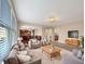 Bright living room with large windows, neutral decor, and an open concept layout with direct access to the kitchen at 643 Bracknell Dr, Avon, IN 46123