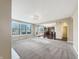 Open living room with plush carpeting, bright windows, and arched doorway to kitchen at 643 Bracknell Dr, Avon, IN 46123