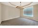 Bright living room featuring neutral walls, a large window, and a modern chandelier at 643 Bracknell Dr, Avon, IN 46123