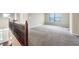Bright loft area with soft carpet, large window, and view to the front entry at 643 Bracknell Dr, Avon, IN 46123