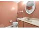 Compact bathroom with a standard toilet, vanity sink, and mirror with neutral decor at 6602 Boston Ridge Ct, Indianapolis, IN 46237