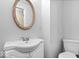 Cozy bathroom featuring a pedestal sink and standard toilet with neutral decor at 6602 Boston Ridge Ct, Indianapolis, IN 46237