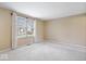 Neutral bedroom featuring wall-to-wall carpet and a large window for natural light at 6602 Boston Ridge Ct, Indianapolis, IN 46237