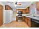 Traditional kitchen featuring wood cabinets, laminate flooring, and stainless steel appliances at 6602 Boston Ridge Ct, Indianapolis, IN 46237