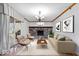Bright living room with brick fireplace, modern chandelier, and sliding doors to outdoor deck at 6602 Boston Ridge Ct, Indianapolis, IN 46237