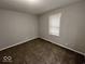 Neutral bedroom featuring a window, plush carpeting, and light gray walls at 709 S Vine St, Muncie, IN 47302
