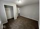 Bedroom with closet, ceiling fan view, plush carpeting, and light gray walls at 709 S Vine St, Muncie, IN 47302