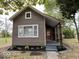 Charming home with neutral siding, an inviting front porch, and fresh landscaping at 709 S Vine St, Muncie, IN 47302