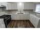 Contemporary kitchen featuring white cabinets, marbled countertops, and stainless steel appliances at 709 S Vine St, Muncie, IN 47302