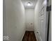 Laundry room with wood flooring and a modern light fixture at 709 S Vine St, Muncie, IN 47302