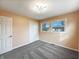 A cozy bedroom featuring two windows, carpet, and a spacious closet at 7224 Rose Dr, Indianapolis, IN 46227