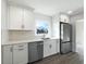 Modern kitchen with white cabinets, stainless steel appliances, and ample counter space, perfect for cooking at 7224 Rose Dr, Indianapolis, IN 46227