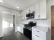 Modern kitchen featuring white cabinets, stainless steel appliances, and sleek countertops at 7224 Rose Dr, Indianapolis, IN 46227