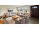 Bright living room featuring hardwood floors, neutral-toned sofas, and a large window offering ample natural light at 7224 Rose Dr, Indianapolis, IN 46227