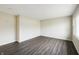 An empty room with hardwood floors, a large window, and natural light create an open and inviting living space at 7224 Rose Dr, Indianapolis, IN 46227