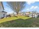 Expansive backyard with lush lawn, storage shed, mature trees, and ample space for outdoor activities at 76 Wyndham Ln, Brownsburg, IN 46112