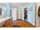 Bright bathroom features blue walls, wood-look floors, and a walk-in closet at 76 Wyndham Ln, Brownsburg, IN 46112