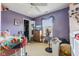 Bedroom in purple with a ceiling fan and natural light from the window at 76 Wyndham Ln, Brownsburg, IN 46112