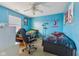 Bedroom with bright blue walls, ceiling fan, and natural light at 76 Wyndham Ln, Brownsburg, IN 46112