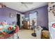 Bedroom in purple with a ceiling fan and natural light from the window at 76 Wyndham Ln, Brownsburg, IN 46112
