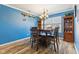 Bright dining room with hardwood floors, a modern chandelier, and seating for six at 76 Wyndham Ln, Brownsburg, IN 46112
