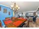 Open dining room showcasing a large table and stylish chandelier, seamlessly connecting to the living area at 76 Wyndham Ln, Brownsburg, IN 46112