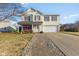 Charming two-story home with a front porch swing and well-manicured lawn with brick walkway at 76 Wyndham Ln, Brownsburg, IN 46112