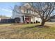 Two-story home featuring a front porch swing, mature trees, and well-maintained lawn at 76 Wyndham Ln, Brownsburg, IN 46112