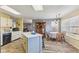 An eat-in kitchen with an island, dining table and wood flooring at 76 Wyndham Ln, Brownsburg, IN 46112