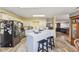 A modern kitchen with an island, black appliances, and wood flooring at 76 Wyndham Ln, Brownsburg, IN 46112