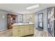 A kitchen island with seating area and wood flooring at 76 Wyndham Ln, Brownsburg, IN 46112