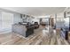 Spacious living room with wood-look floors, comfortable seating, and an open floor plan at 76 Wyndham Ln, Brownsburg, IN 46112