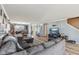 Open-concept living room with hardwood floors, comfortable sofa, and dining area in background at 76 Wyndham Ln, Brownsburg, IN 46112