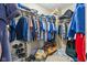 Spacious walk-in closet with rods and shelving, full of clothing and accessories at 76 Wyndham Ln, Brownsburg, IN 46112