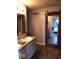 Bathroom with dual sinks, granite countertop, decorative mirrors, and sliding barn door at 7835 E 296Th St, Atlanta, IN 46031