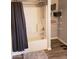 Bathroom features a tub and shower combination with gray shower curtain and built-in shelves at 7835 E 296Th St, Atlanta, IN 46031