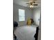 Neutral bedroom with large window, ceiling fan, and neutral carpet at 7835 E 296Th St, Atlanta, IN 46031