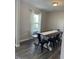 Inviting dining room featuring dark wood flooring, a farmhouse table, and bright natural light at 7835 E 296Th St, Atlanta, IN 46031