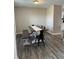 Bright dining room with wood floors, farmhouse table and bench, and neutral paint at 7835 E 296Th St, Atlanta, IN 46031
