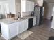A well-lit kitchen with stainless steel refrigerator, granite countertops, and updated cabinetry and modern fixtures at 7835 E 296Th St, Atlanta, IN 46031