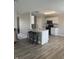 Open-concept kitchen featuring granite countertops, stainless steel appliances, breakfast bar and hardwood-style floors at 7835 E 296Th St, Atlanta, IN 46031